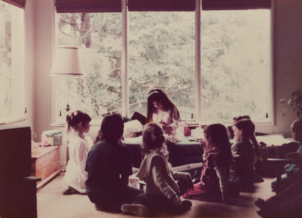 An old photo of Ada Limón seated near her favorite window surrounded by friends on her birthday at her family home in Glen Ellen. (Courtesy of Ada Limón)