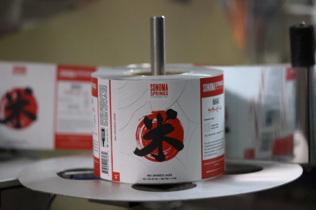 Labels for Mai Japanese Lager run through the canning line at Sonoma Springs Brewing Co. in Sonoma Tuesday, Feb. 3, 2026. (Beth Schlanker / The Press-Democrat)