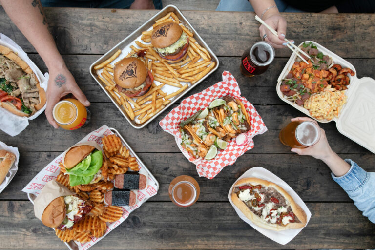 A selection of food from pop-up vendors at Old Caz Beer in Rohnert Park. Clockwise from top left, Mamadios' Italian roast pork sandwich; burgers and fries from The Spot food truck; Hawaiian plate lunch from The Poke Truck; Philly cheesesteak from Mamadios; tacos from Galvan's; fried chicken sandwich, fried soft shell crab sandwich, Spam musubi and waffle fries from Shokakko. (Eileen Roche)