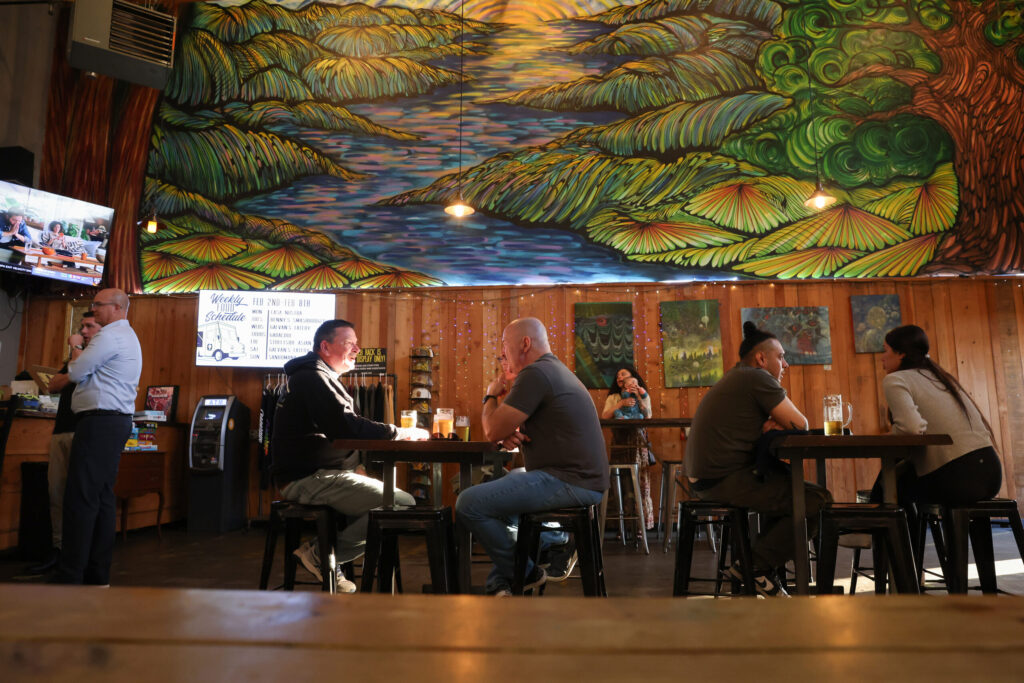Guests enjoy their drinks under a large painting at Cooperage Brewing Company in Santa Rosa on Tuesday, February 3, 2026. (Christopher Chung/The Press Democrat)