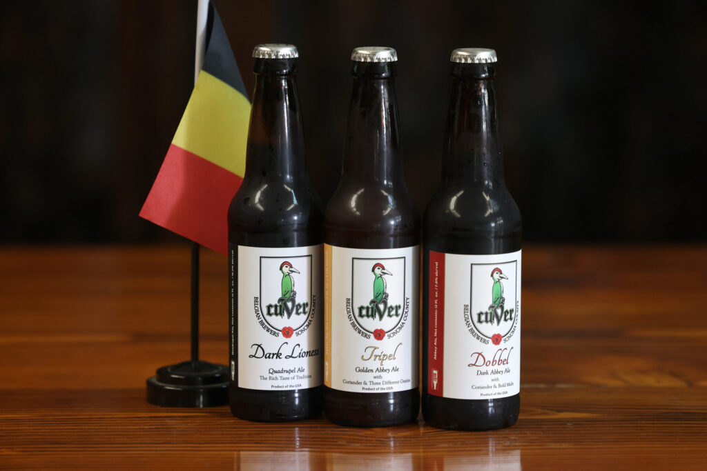 From left, bottles of Dark Lioness Quadrupel, Tripel Golden Abbey Ale and Dobbel Dark Abbey Ale at Cuver Brewing in Windsor Sunday, Feb. 8, 2026. (Beth Schlanker / The Press Democrat)