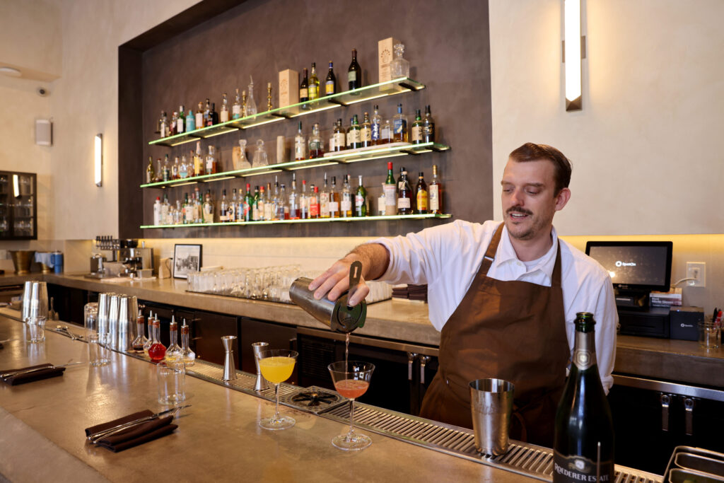 Server Chris Arntz pours a Violette Royale cocktail at Bijou Restaurant in Petaluma Sunday, Feb. 22, 2026. (Beth Schlanker / The Press Democrat)