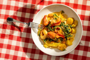 Seafood Pappardelle with scallops, prawns, lobster meat, Calabrian peppers, arugula, fresh tomatoes and a saffron lobster butter sauce from the historic Swiss Hotel Thursday, Feb. 19, 2026 on the square in Sonoma. (John Burgess/The Press Democrat)
