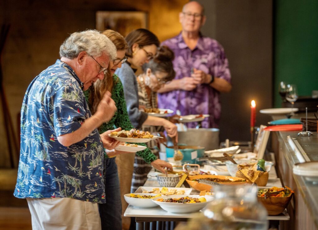 Sonoma County foodies fill their plates from a buffet of recipes from the Russian recipes book “Kachka,” chosen by Songbird Parlour owner/chef Lauren Kershner for the first Cookbook Club Tuesday, March 10, 2026 in Glen Ellen. (John Burgess/The Press Democrat)