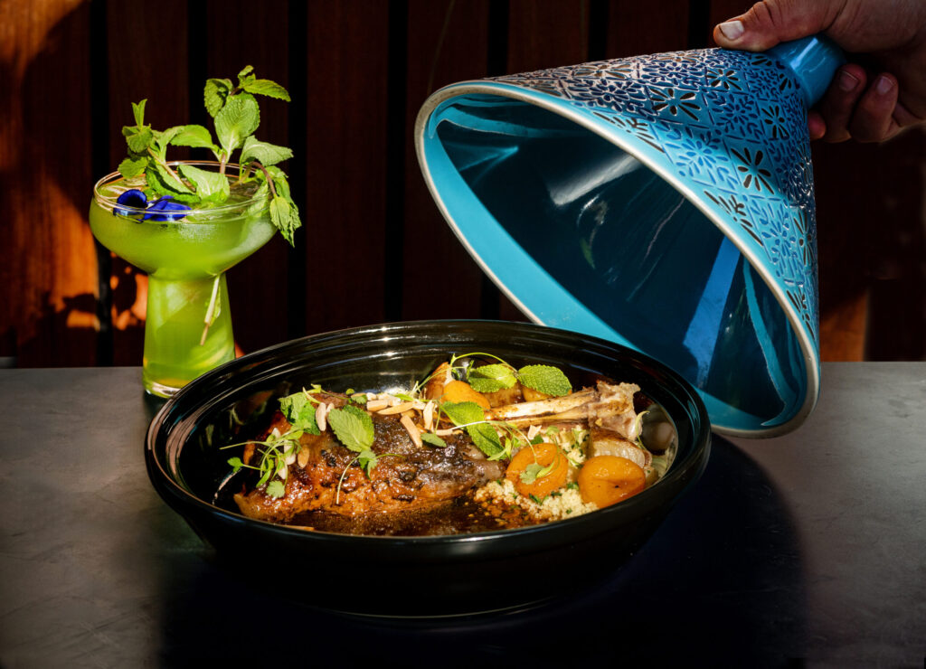 Lamb Shank Tagine with ras el hanout, apricots and almonds with a Moroccan Mint Tea Fizz from Juju’s, a French-Moroccan dinner pop-up in the Acorn Café space on the square in Healdsburg. Photo taken Thursday, March 19, 2026. (John Burgess/The Press Democrat)