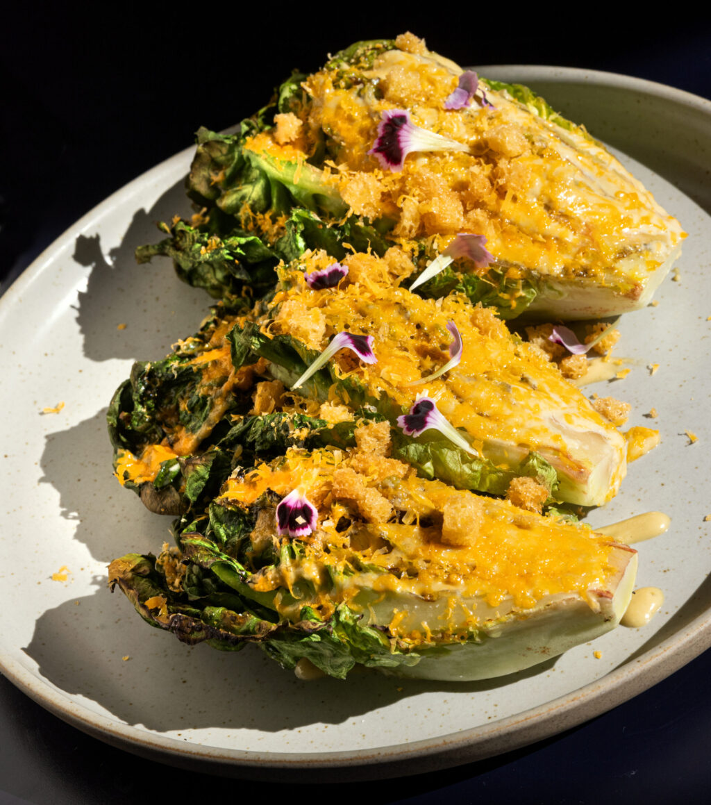 Grilled Caesar with sourdough croutons, grated mimolette cheese and lime from Juju’s, a French-Moroccan dinner pop-up in the Acorn Café space on the square in Healdsburg. Photo taken Thursday, March 19, 2026. (John Burgess/The Press Democrat)