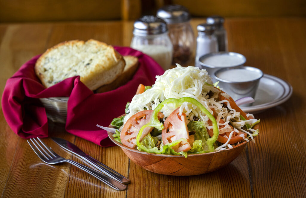 The Lisa Iskin Salad with tomatoes, green pepper, mushrooms, chopped olives and topped with cheese from Old Chicago Pizza in Petaluma Thursday, March 19, 2026. (John Burgess/The Press Democrat)