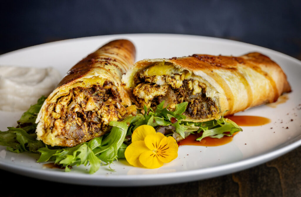 Shawarma wrap with chicken, caramelized onions, extra virgin olive oil, sumac dibs ruman and toum from the lunch-only menu at Mazza Levantine Kitchen Thursday, March 26, 2026 in northeast Petaluma. (John Burgess / The Press Democrat)