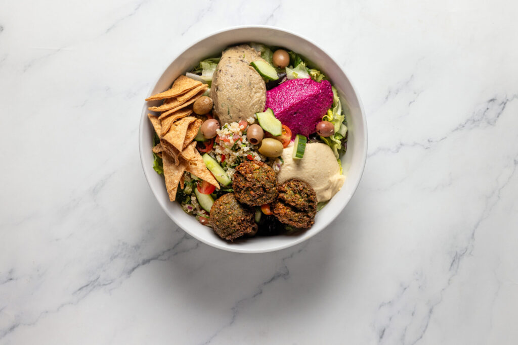 Maccabi Bowl with falafel, hummus, baba ganoush, beet and walnut dip, quinoa tabouleh, mixed greens and whole wheat chips from Zoftig Eatery Monday, March 30, 2026 in Santa Rosa. (John Burgess/The Press Democrat)