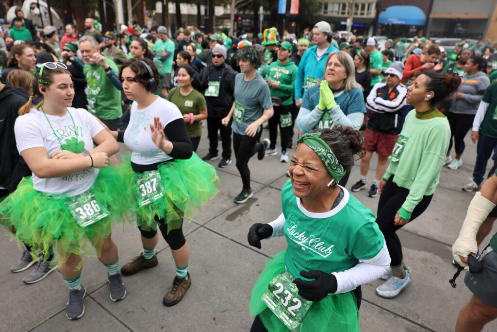 Christina Lindh, right, warms up at the start of the St. Patrick’s Day 5k at Old Courthouse Square in Santa Rosa Sunday, March 16, 2025. (Beth Schlanker / The Press Democrat)