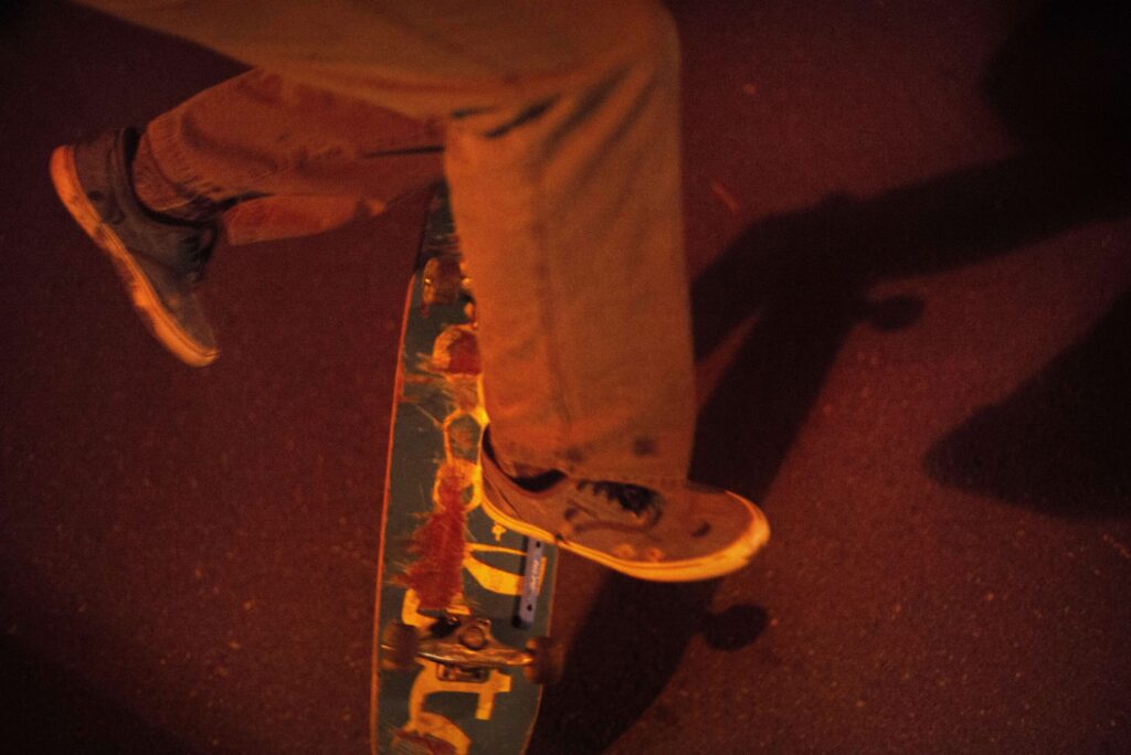 Skateboard dad club member Klaus Rappensperger, 41, doing kick flips during a skateboard session in a parking lot near the Chevron station at Mendocino and Steele Lane in Santa Rosa, June 15, 2018. (Erik Castro/for The Press Democrat)