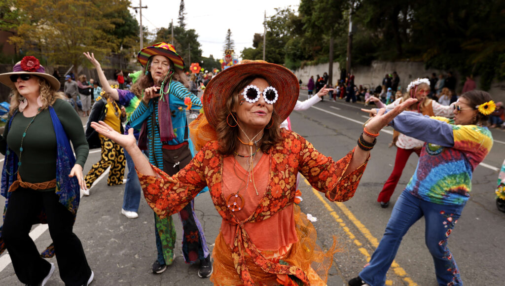Deena Broderick from Coaches Corner in Sebastopol, dance with her crew during the 79th Annual Apple Blossom Parade and Festival, Saturday, April 26, 2025. (Kent Porter / The Press Democrat)