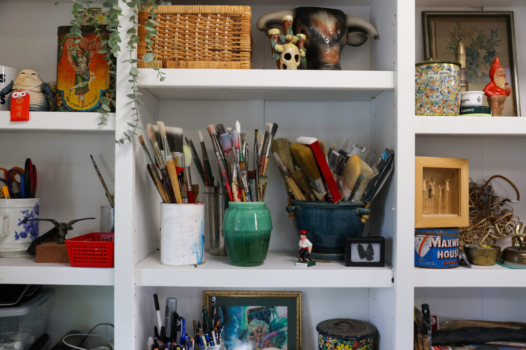 Shelves in Jake Messing’s studio hold paint brushes among other knickknacks in Healdsburg on Friday, February 6, 2026. (Christopher Chung/The Press Democrat)