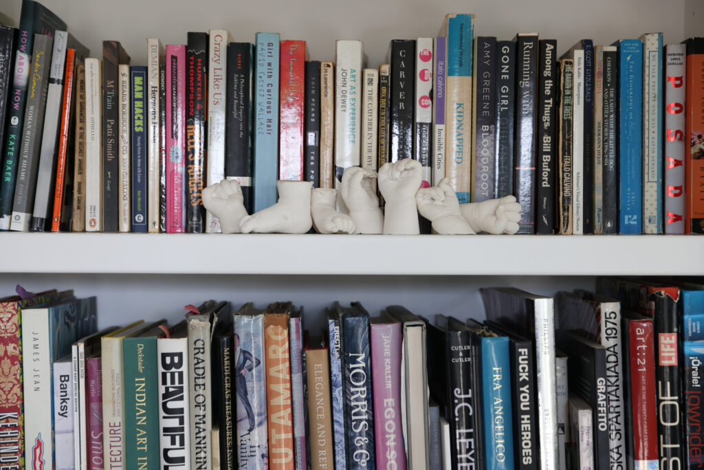 Casts of Jake and Corrin Messing’s children’s hands and feet adorn a bookshelf in their Healdsburg home on Friday, February 6, 2026. (Christopher Chung/The Press Democrat)