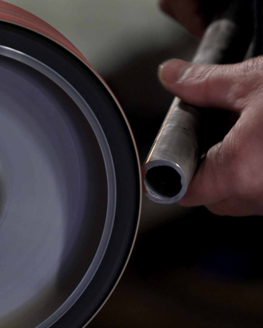 Klaus Rappensperger smooths the edges of a pipe, which will be used in a custom cabinet job at Schnitzkraft Steel Artistry in Santa Rosa, Tuesday, Feb. 10, 2026. (Kent Porter / The Press Democrat)