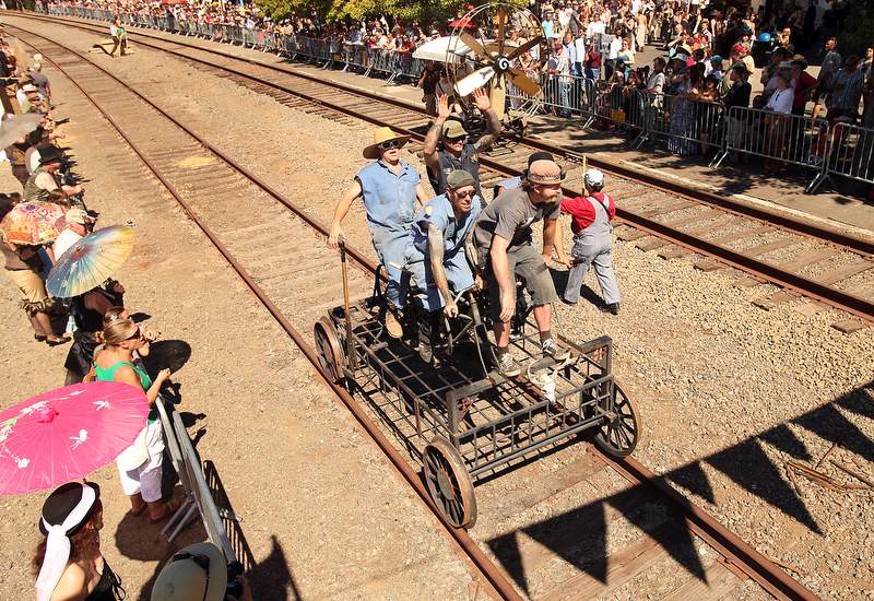 Joey Castor, clockwise from top left, Klaus Rappensperger, Joshua Thwaites (obscured), David Farish and Neil Espenship pilot their vehicle down the tracks during The 3rd Annual 2010 Great West End & Railroad Square Handcar Regatta, in Santa Rosa, on Sunday, September 26, 2010. (The Press Democrat, file)