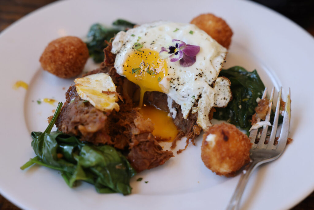 Birria hash with fried eggs, spinach and goat cheese balls at Parkside Eats in Santa Rosa Monday, April 13, 2026. (Beth Schlanker / The Press Democrat)