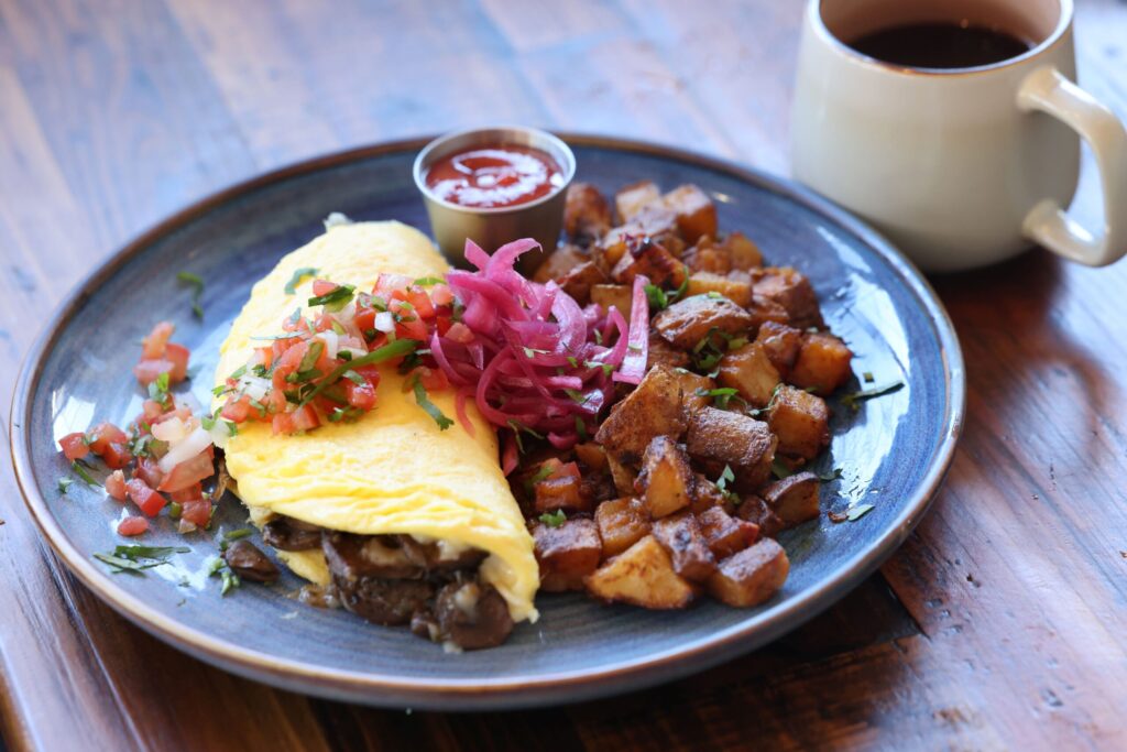 The mushroom omelet with pico de gallo, pickled red onions and a side of country potatoes at Parkside Eats in Santa Rosa Monday, April 13, 2026. (Beth Schlanker / The Press Democrat)
