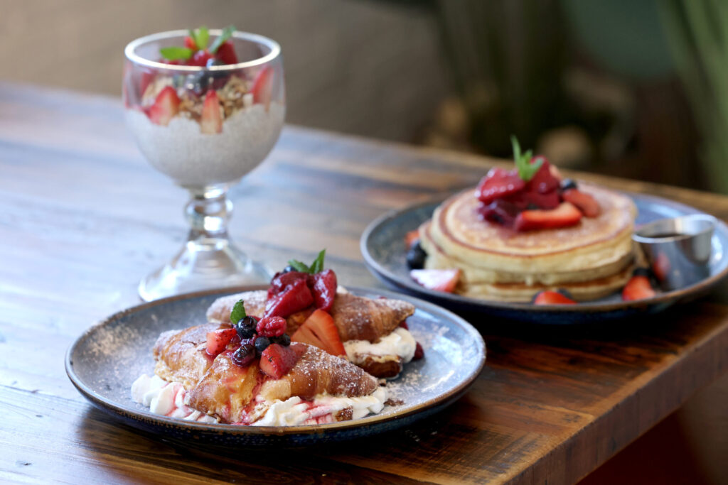 Tres leches French toast made with croissants, the coconut chia parfait with housemate granola and berries, and the buttermilk pancakes with fruit at Parkside Eats in Santa Rosa Monday, April 13, 2026. (Beth Schlanker / The Press Democrat)