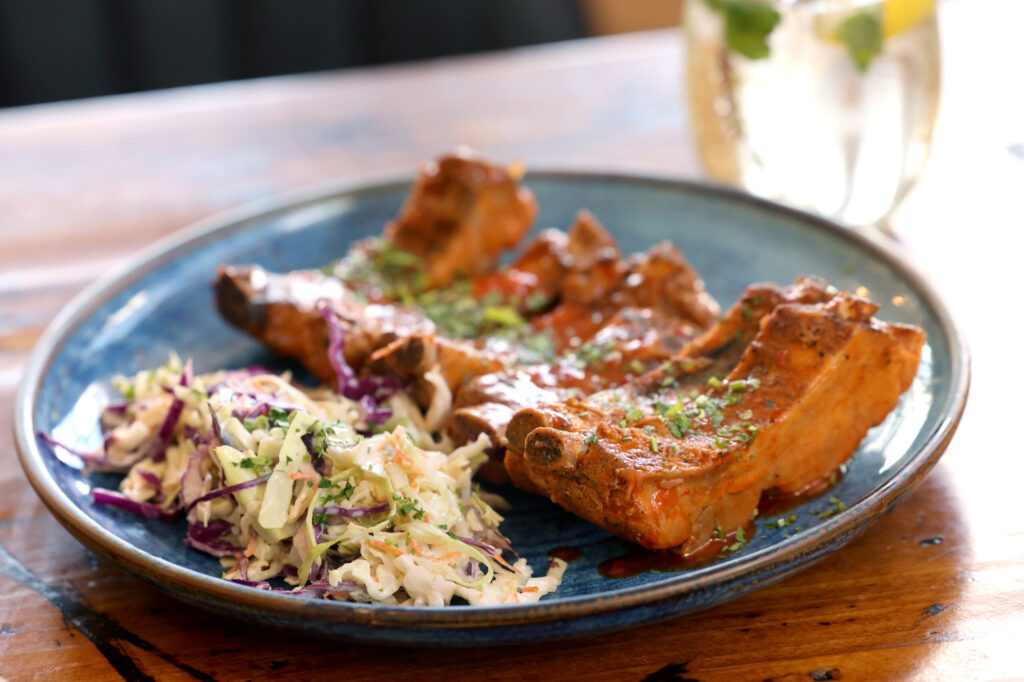 Baby back ribs with housemate barbecue sauce and a side of slaw at Parkside Eats in Santa Rosa Monday, April 13, 2026. (Beth Schlanker / The Press Democrat)