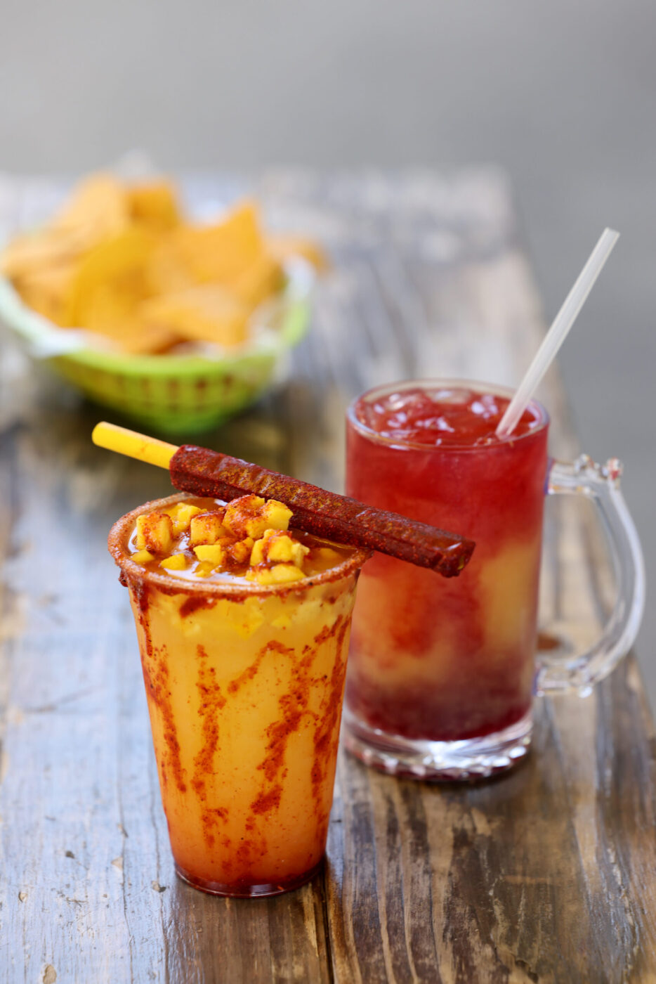 Two popular drinks include the Michelagua, left, a mango and pineapple juice spiced with chamoy and Tajin and topped with mango chunks, and the Mango Piña Sunset, right, with mango, pineapple and hibiscus at Don Julio's Latin Grill in Rohnert Park Monday, April 13, 2026. (Beth Schlanker / The Press Democrat)