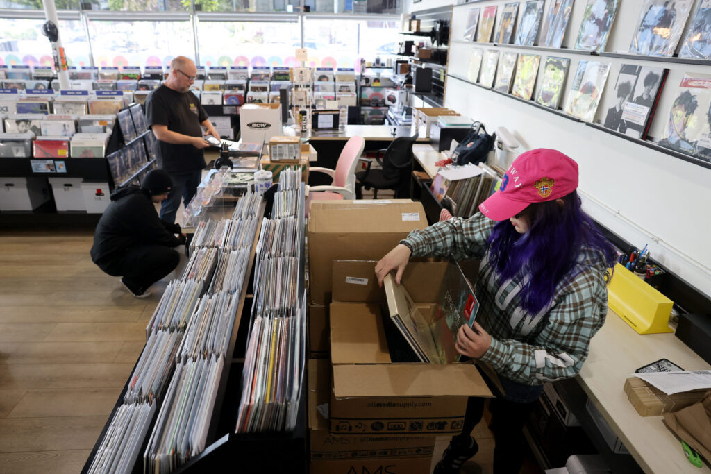 Store manager Justice Richie, right, opens boxes of newly delivered records for the upcoming Record Store Day at Paradise Found Records and Music in Petaluma Tuesday, April 14, 2026. (Beth Schlanker / The Press Democrat)