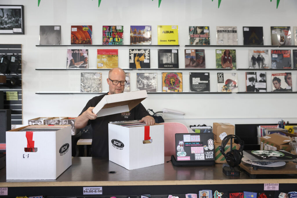 Owner David Lannon looks through records to be on display at the upcoming Record Store Day at Paradise Found Records and Music in Petaluma Tuesday, April 14, 2026. (Beth Schlanker / The Press Democrat)