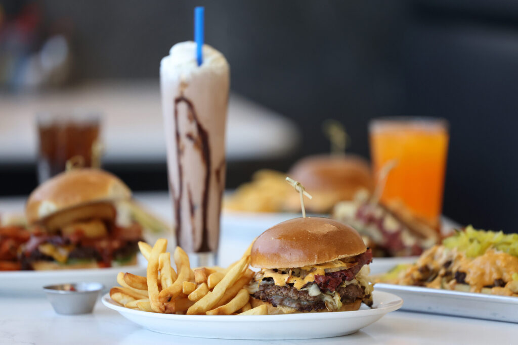 The P & B, made with two beef patties, pastrami, Swiss cheese, sauerkraut, grilled onions, pickles and house-made Pressed sauce, with a side of fries at Pressed in Rohnert Park Friday, April 17, 2026. (Beth Schlanker / The Press Democrat)