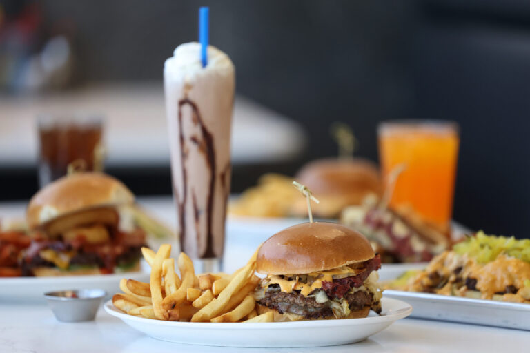 The P & B, made with two beef patties, pastrami, Swiss cheese, sauerkraut, grilled onions, pickles and house-made Pressed sauce, with a side of fries at Pressed in Rohnert Park Friday, April 17, 2026. (Beth Schlanker / The Press Democrat)