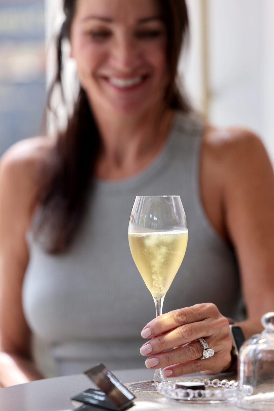 Guest Sharyn DeLaurentis enjoys a glass of Blanc de Blancs sparkling wine at Sol Rei Wine tasting room in Sonoma Thursday, April 23, 2026. (Beth Schlanker / The Press Democrat)