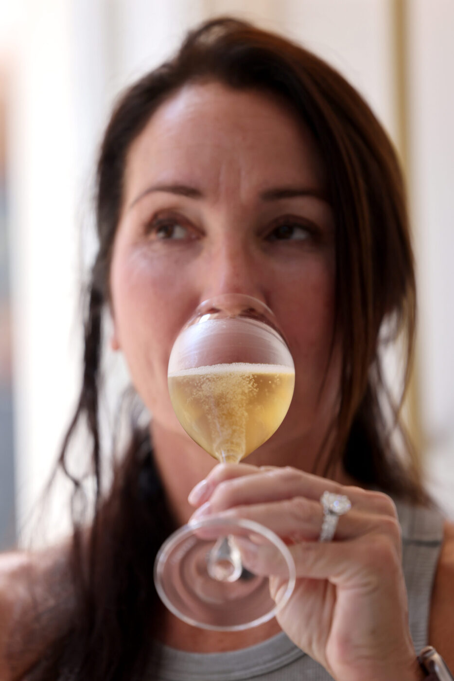 Guest Sharyn DeLaurentis sips a glass of Blanc de Blancs sparkling wine at Sol Rei Wine tasting room in Sonoma Thursday, April 23, 2026. (Beth Schlanker / The Press Democrat)