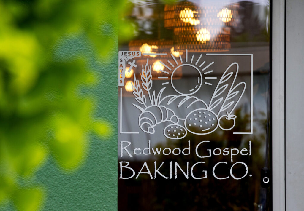 The new Redwood Gospel Baking Company’s sign is displayed on the front door entering the cafe in Santa Rosa, Friday, April 10, 2026. (Darryl Bush/For The Press Democrat)