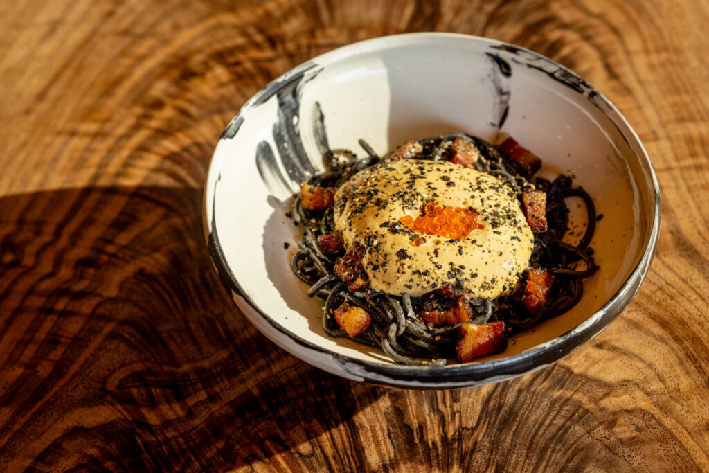 Uni Carbonara with squid ink chimaera pasta, pancetta, furikake and the uni from local purple sea urchins from Sea Ranch Lodge chef Ryan Seal Thursday, Feb. 6, 2026. (John Burgess/The Press Democrat)