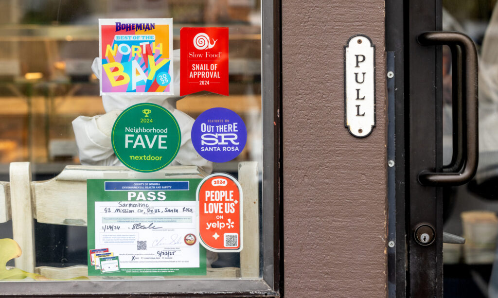 The Slow Food Snail of Approval award Tuesday, Feb. 10, 2026 on Sarmentine Bakery window in Santa Rosa. (John Burgess/The Press Democrat)