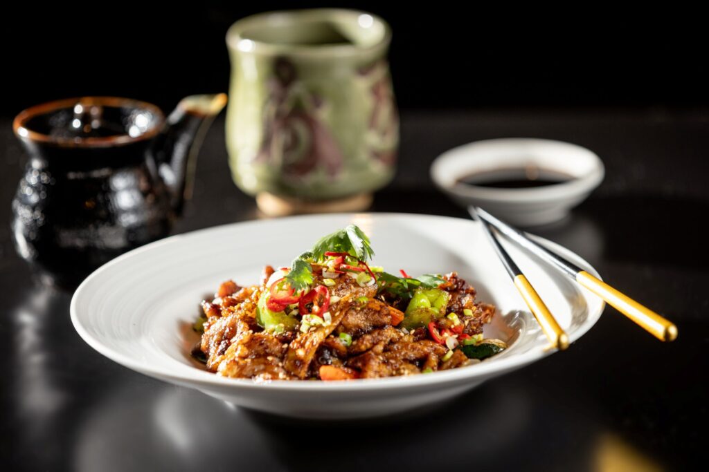 Spicy Plum Sauce Pork sautéed with vegetables from Osake Japanese restaurant Thursday, April 3, 2026 in Santa Rosa. (John Burgess / The Press Democrat)