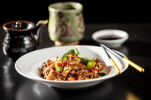 Spicy Plum Sauce Pork sautéed with vegetables from Osake Japanese restaurant Thursday, April 3, 2026 in Santa Rosa. (John Burgess / The Press Democrat)