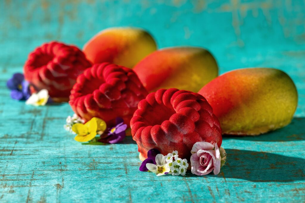 Raspberry White Chocolate Tart, left, and a Mango-Passion Fruit Mousse Tart from Fleur Sauvage Chocolates Thursday, April 2, 2026 in Windsor. (John Burgess/The Press Democrat)
