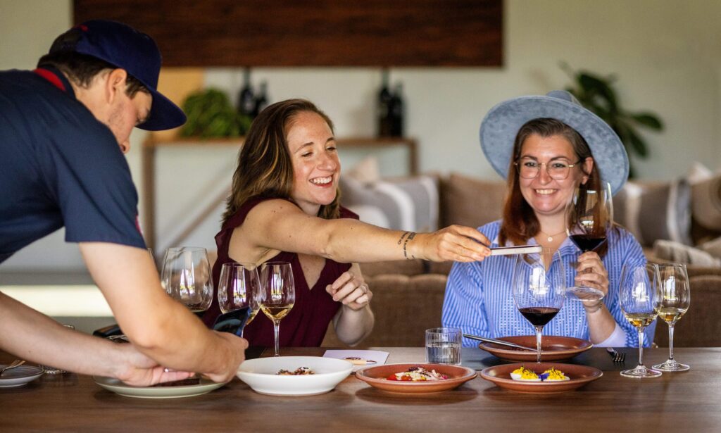 Chef Will Saladin presents Carli Baxter, left, and Jacey Ohlinger with seasonal dishes crafted with ingredients harvested straight from the Clif Family Winery & Farm and other local sources paired with their wines at the “Farm to Brunch Tasting Experience” Friday, April 24, 2026 in St. Helena. (John Burgess/The Press Democrat)