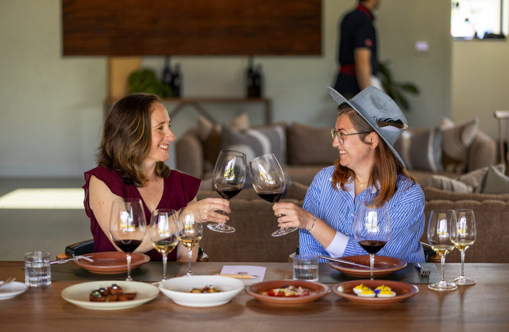 Carli Baxter, left, and Jacey Ohlinger taste Clif Family Winery & Farm wines paired with seasonal dishes crafted with ingredients harvested straight from their organic farm and local sources during the “Farm to Brunch Tasting Experience” Friday, April 24, 2026 in St. Helena. (John Burgess/The Press Democrat)