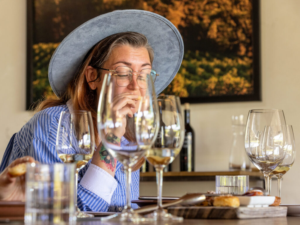 Jacey Ohlinger tastes a biscuit from the Model Bakery paired with a Clif Family Winery & Farm white wine during the “Farm to Brunch Tasting Experience” Friday, April 24, 2026 in St. Helena. (John Burgess/The Press Democrat)