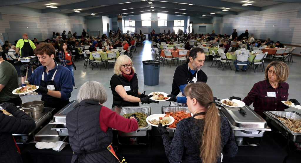 Volunteers plate Thanksgiving fixings, Wednesday, Nov. 26, 2025, during the Redwood Gospel Missions’ Great Thanksgiving Banquet at the Sonoma County Fairgrounds in Santa Rosa. (Kent Porter / The Press Democrat)