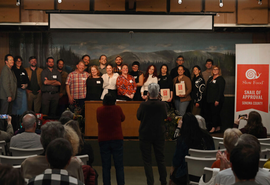 All the award winners take the stage for one final applause during the Snail of Approval awards ceremony held at Grange Hall in Sebastopol, Wednesday, Feb. 28, 2024. (Erik Castro / For The Press Democrat)