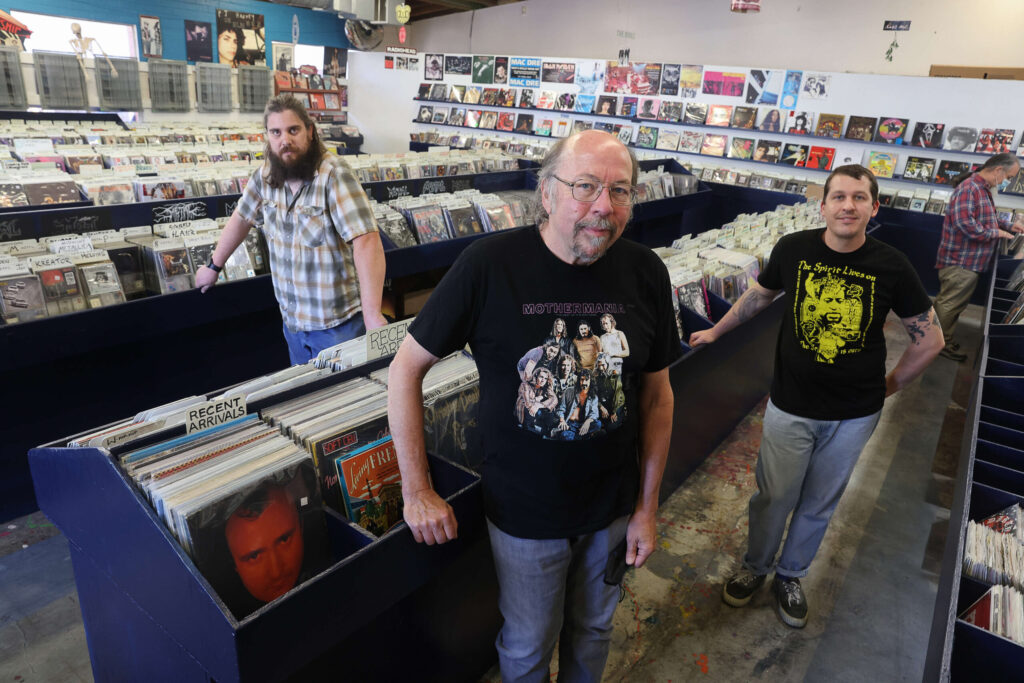 The co-owners of The Next Record Store are Doug Jayne, center, and his wife Barrett (not pictured), his son Ethan Jayne, right, and Gerry Stumbaugh. Hoyt Wilhelm was also co-owner of The Last Record Store. (Christopher Chung / The Press Democrat)
