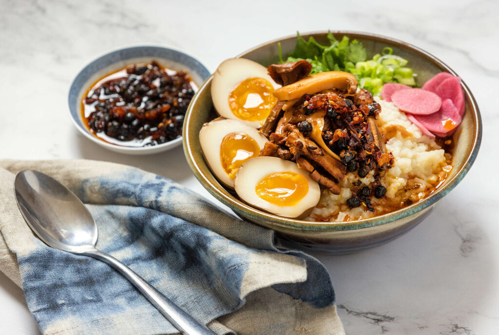 Congee with Mushroom and Big Spoon Sauce Co. Magic Beans sauce from owners Lani Chan and Nate Bender Tuesday, December 6, 2022.