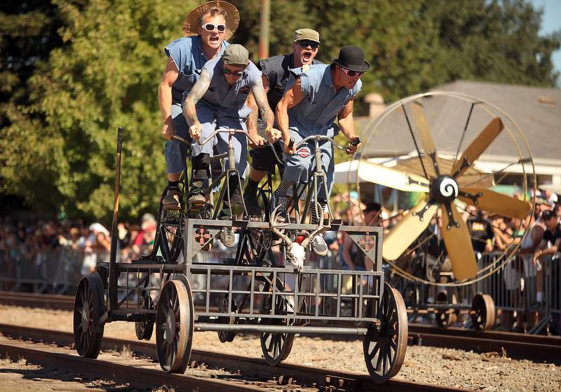 Joey Castor, clockwise from top left, Klaus Rappensperger, Joshua Thwaites and Neil Espenship pilot their vehicle down the tracks during The 3rd Annual 2010 Great West End & Railroad Square Handcar Regatta, in Santa Rosa, on Sunday, September 26, 2010. (The Press Democrat, file)