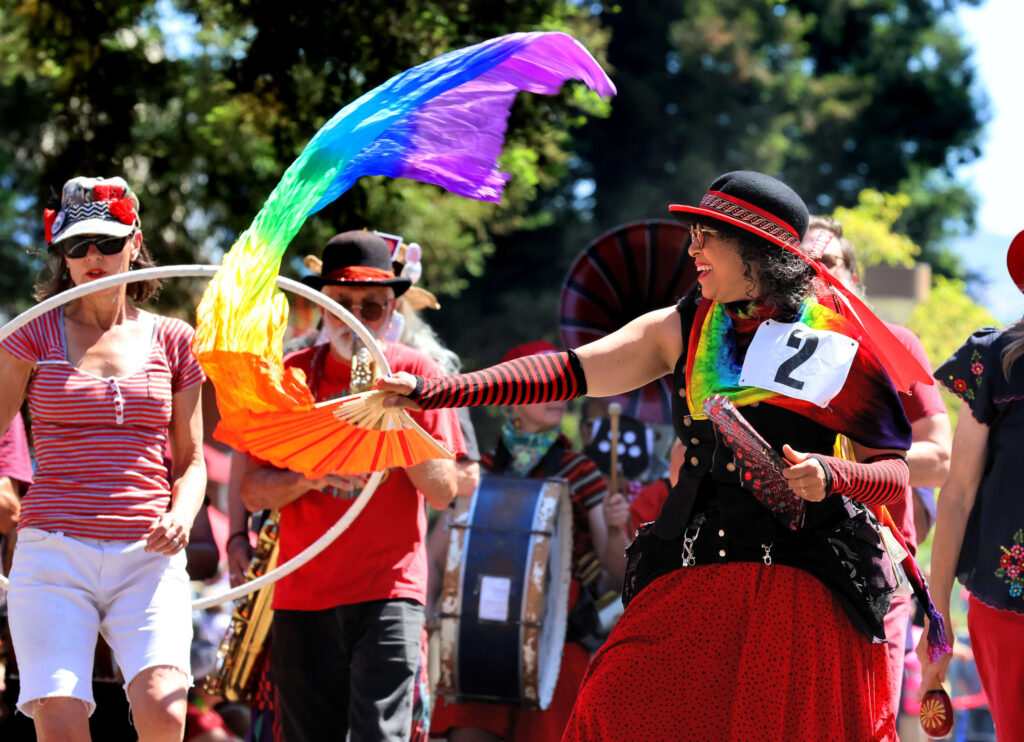 Juanita Watkins of Cotati, waves a flag as she dances with the "Hubbub Club" in the parade during the 2025 Sonoma County Pride Parade in Santa Rosa on Saturday, May 31, 2025. (Darryl Bush / For The Press Democrat)