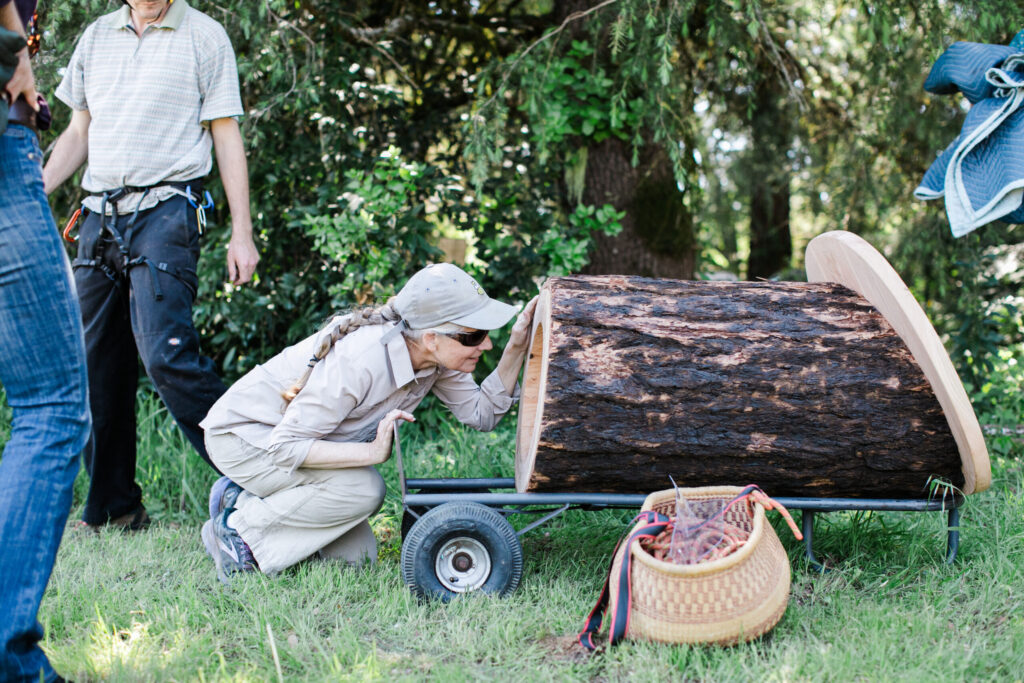 Laura Cheever, right, inspects an Apis Arborea TreeNest before it's installed at her Sebastopol apple farm. (Eileen Roche)