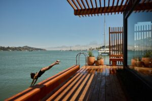 Woman diving into the bay from FJORD sauna in Sausalito, California.