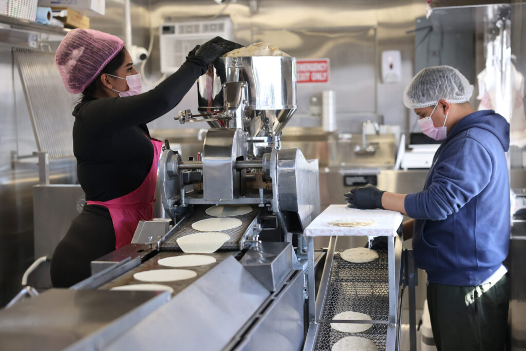 Employees Mia Espinoza, left, and Jesus Mandonado make fresh tortillas at Tortilleria Mexico Mi Amor in Napa Thursday, Feb. 5, 2026. (Beth Schlanker / The Press Democrat)