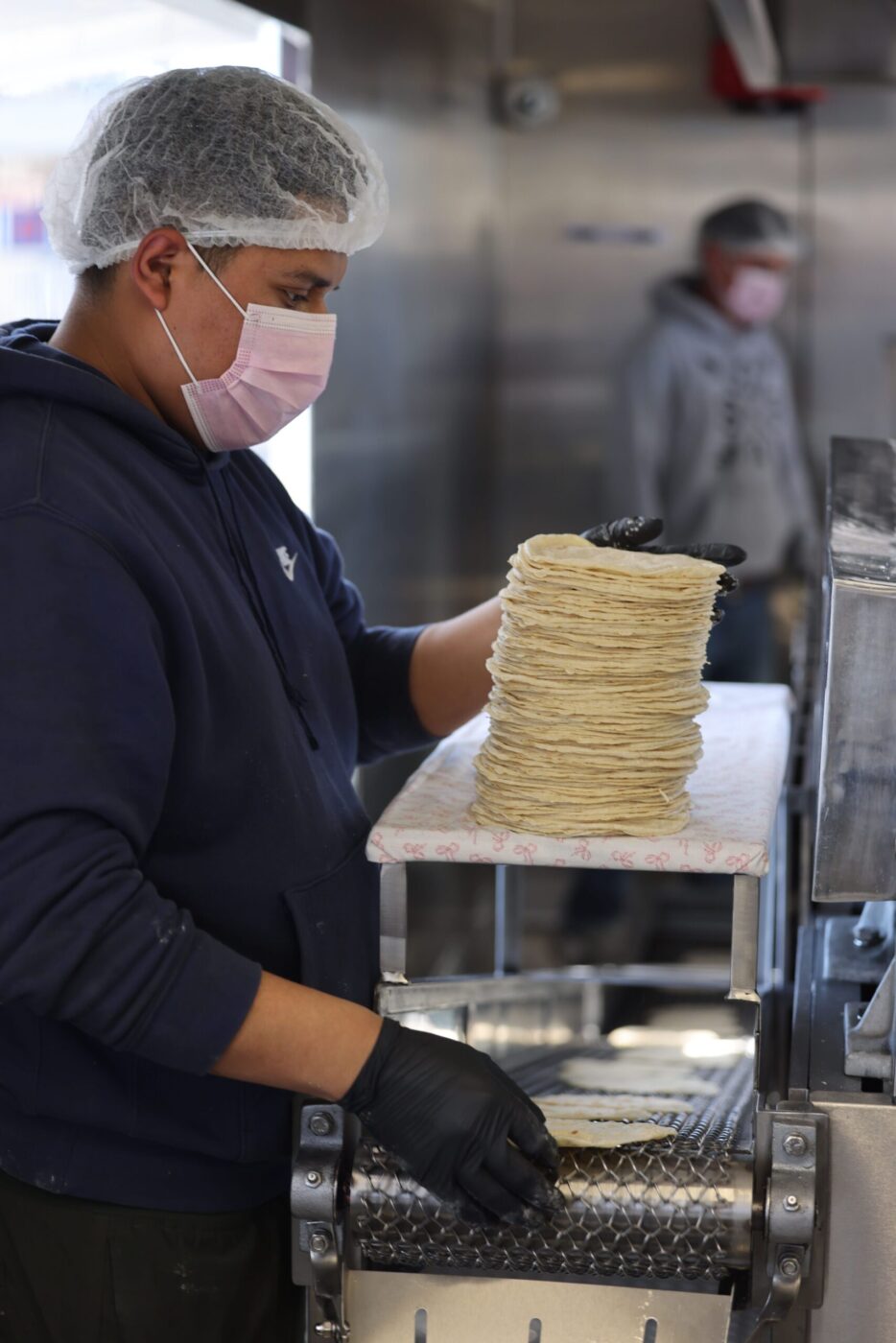 Employee Jesus Mandonado stacks freshly made tortillas at Tortilleria Mexico Mi Amor in Napa Thursday, Feb. 5, 2026. (Beth Schlanker / The Press Democrat)
